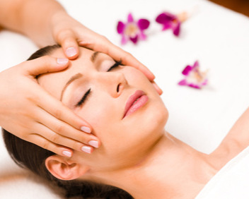 Frau mit geschlossenen Augen die eine Kopfmassage bekommt.